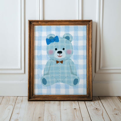 Blue gingham teddy bear nursery wall art print in a wooden frame, perfect for baby boy room decor. Features a cute teddy with a blue bow and a brown bow tie on a checkered background.